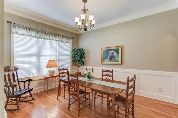 a view of a dining room with furniture and chandelier