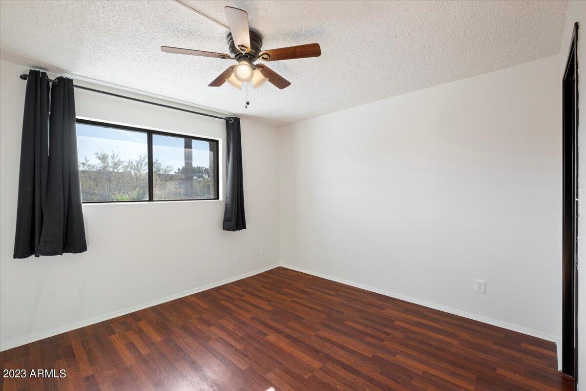 2524 South El Paradiso, Unit 50 Mesa, AZ 85202 - Photo 16 of 36 a view of empty room with wooden floor and fan
