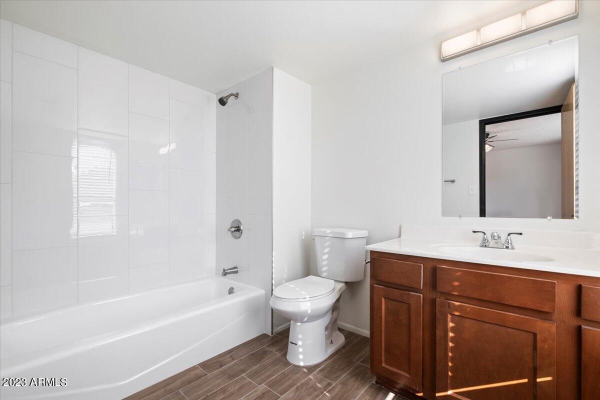 2524 South El Paradiso, Unit 50 Mesa, AZ 85202 - Photo 18 of 36 a bathroom with a bathtub shower sink vanity mirror and toilet