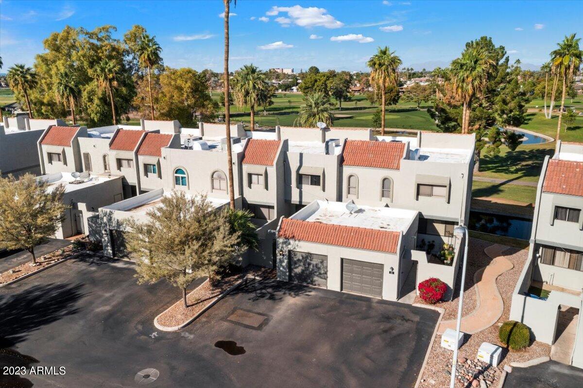 2524 South El Paradiso, Unit 50 Mesa, AZ 85202 - Photo 25 of 36 an aerial view of residential houses with outdoor space