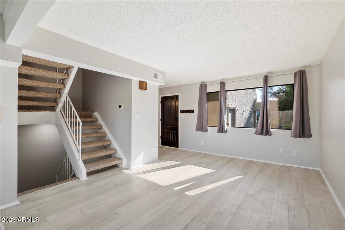 2524 South El Paradiso, Unit 50 Mesa, AZ 85202 - Photo 4 of 36 a view of entryway and hall with wooden floor
