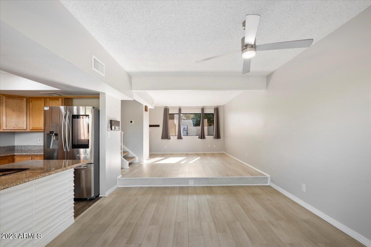 2524 South El Paradiso, Unit 50 Mesa, AZ 85202 - Photo 5 of 36 a view of a large kitchen with wooden floor and a sink