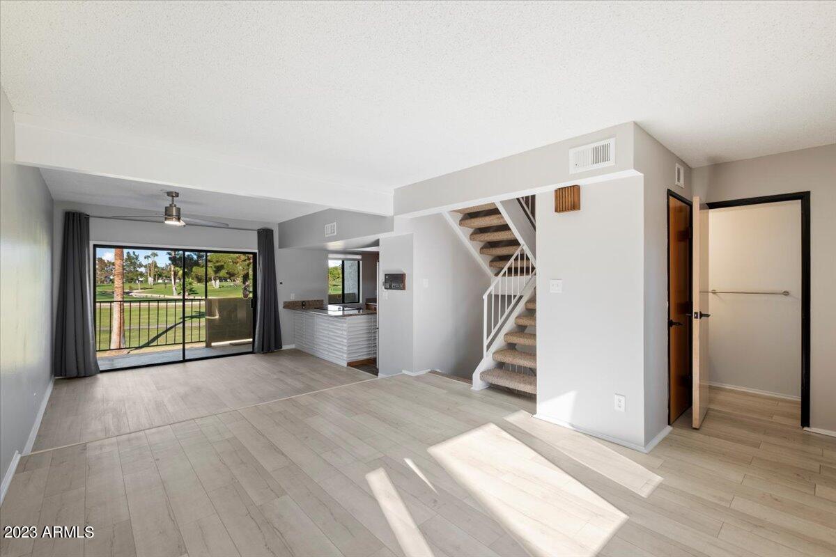 2524 South El Paradiso, Unit 50 Mesa, AZ 85202 - Photo 6 of 36 a view of a hallway with furniture and staircase