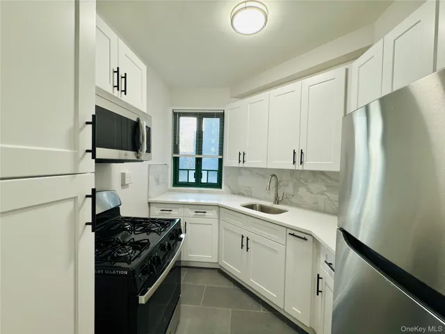 a kitchen with a sink stove and refrigerator