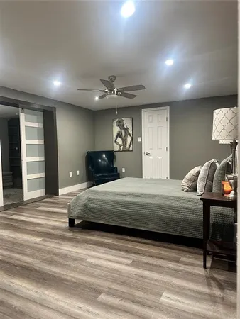 a bedroom with a bed and a lamp