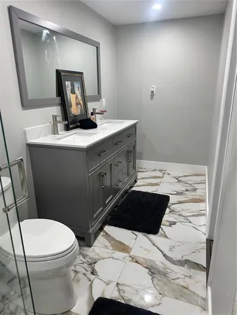a bathroom with a sink toilet and mirror