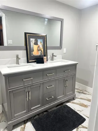 a bathroom with a sink and a mirror