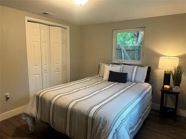 a bedroom with a bed and a window