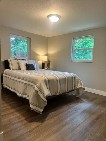a view of a room with wooden floor and window