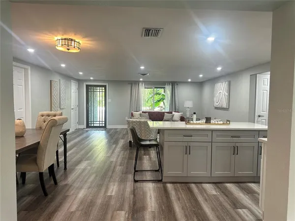 a kitchen with a sink cabinets and wooden floor
