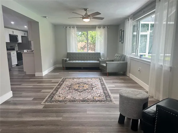 a view of a hallway with furniture and windows
