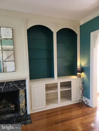 a kitchen with stainless steel appliances wooden floor and a sink