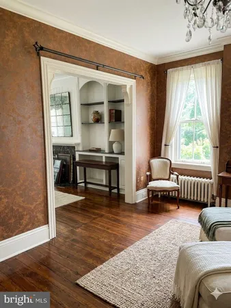 a view of a livingroom with wooden floor and a large window