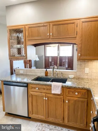 a kitchen with stainless steel appliances granite countertop a sink a granite counter tops and a window