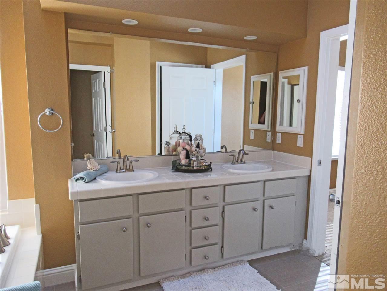 2509 Starr Meadows Loop Reno, NV 89519 - Photo 12 of 18 a bathroom with a double vanity sink and mirror