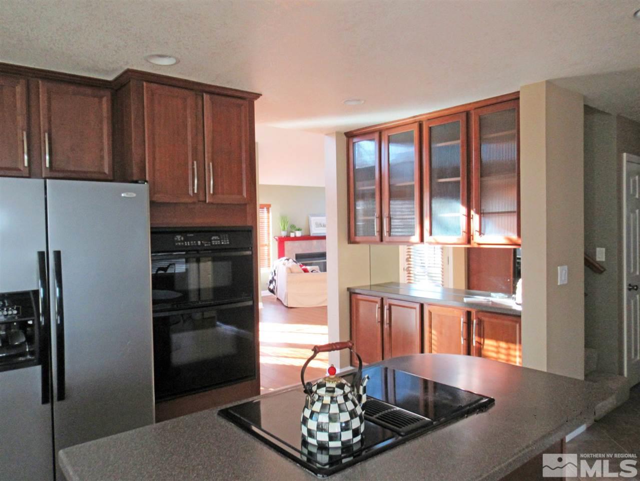 2509 Starr Meadows Loop Reno, NV 89519 - Photo 6 of 18 a kitchen with stainless steel appliances granite countertop a refrigerator and a counter top space