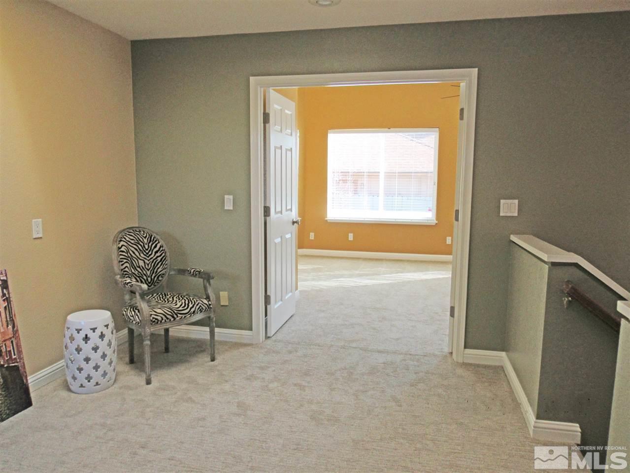 2509 Starr Meadows Loop Reno, NV 89519 - Photo 10 of 18 a furnished livingroom with a window and a chair
