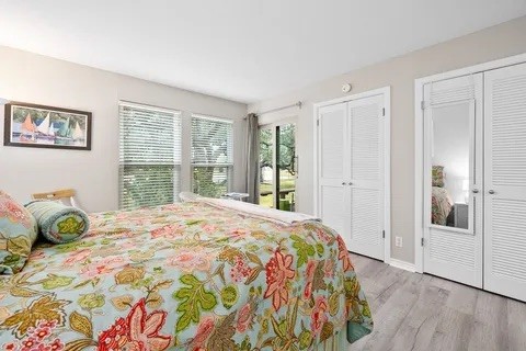 2003 North Fulton Beach Road, Unit 43 Rockport, TX 78382 - Photo 10 of 30 Primary bedroom features two closets and sitting area by sliding glass door that leads to deck.