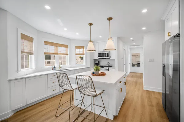 a large kitchen with granite countertop lots of counter space and window