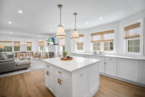 a open kitchen with stainless steel appliances granite countertop a sink stove and wooden floor