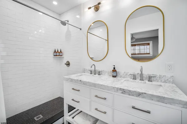 a bathroom with 2 sink and a mirror