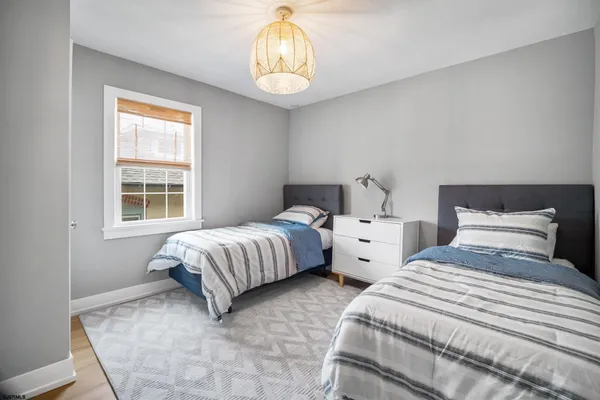 a bedroom with two beds and a window