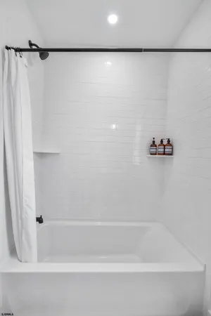 a bathroom with a shower and a bath tub