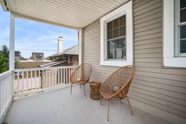 a view of a chair and table in the balcony