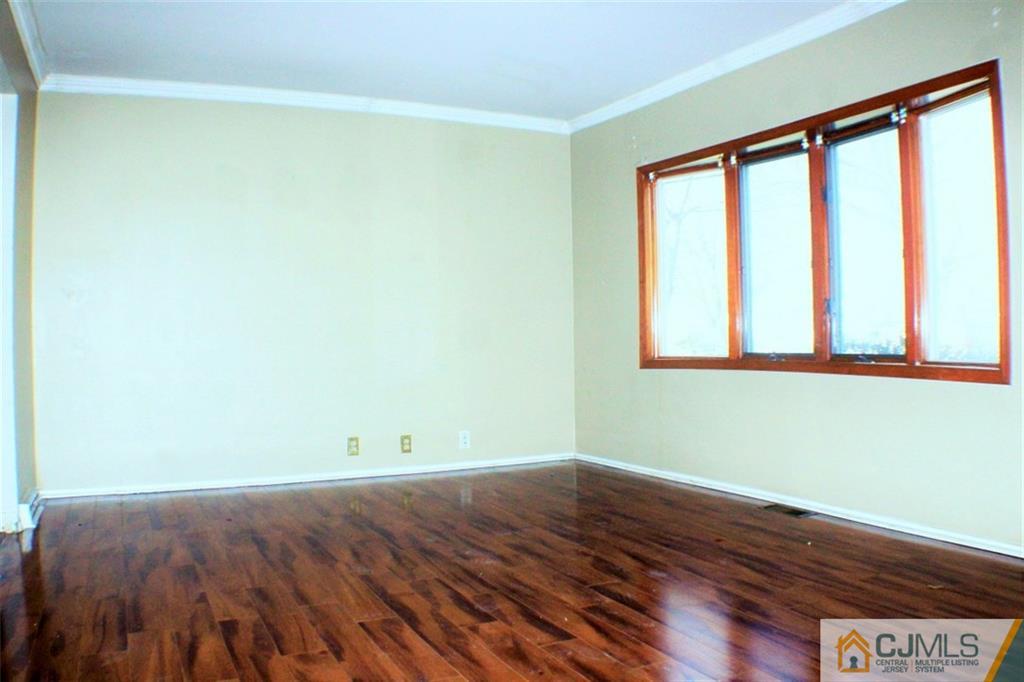 17 Rodney Road East Brunswick, NJ 08816 - Photo 2 of 16 a view of empty room with wooden floor and fan