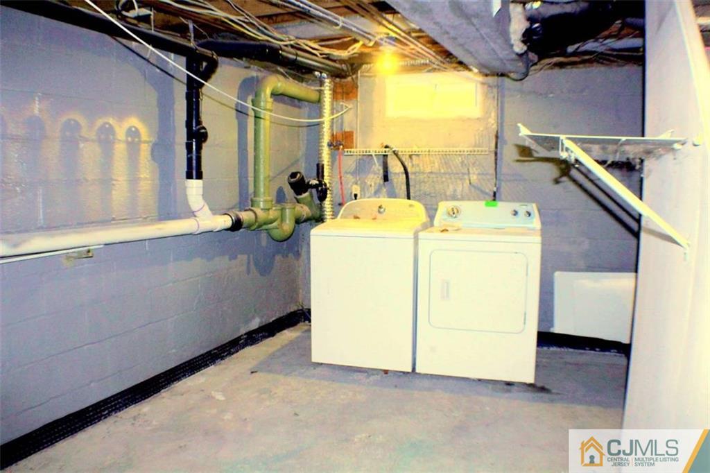17 Rodney Road East Brunswick, NJ 08816 - Photo 13 of 16 a view of a storage & utility room with washer and dryer