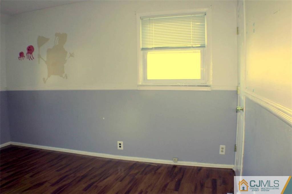 17 Rodney Road East Brunswick, NJ 08816 - Photo 16 of 16 an empty room with a window