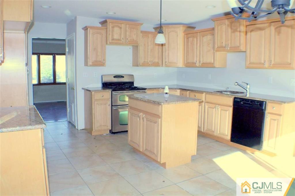 17 Rodney Road East Brunswick, NJ 08816 - Photo 4 of 16 a kitchen with a sink a stove and cabinets