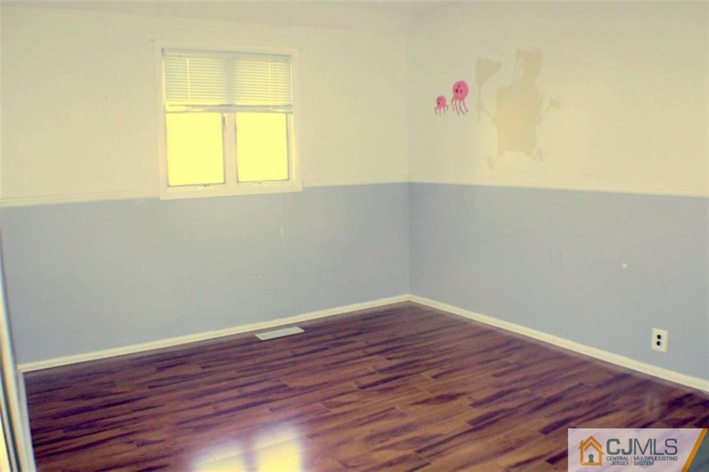 17 Rodney Road East Brunswick, NJ 08816 - Photo 6 of 16 an empty room with a window