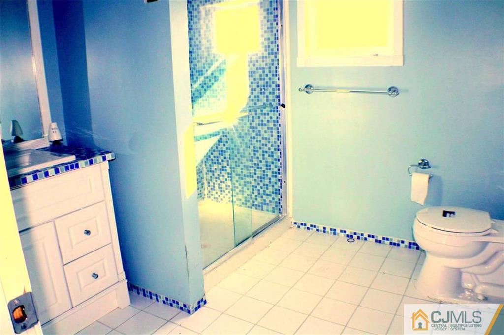 17 Rodney Road East Brunswick, NJ 08816 - Photo 8 of 16 a bathroom with a toilet and a shower