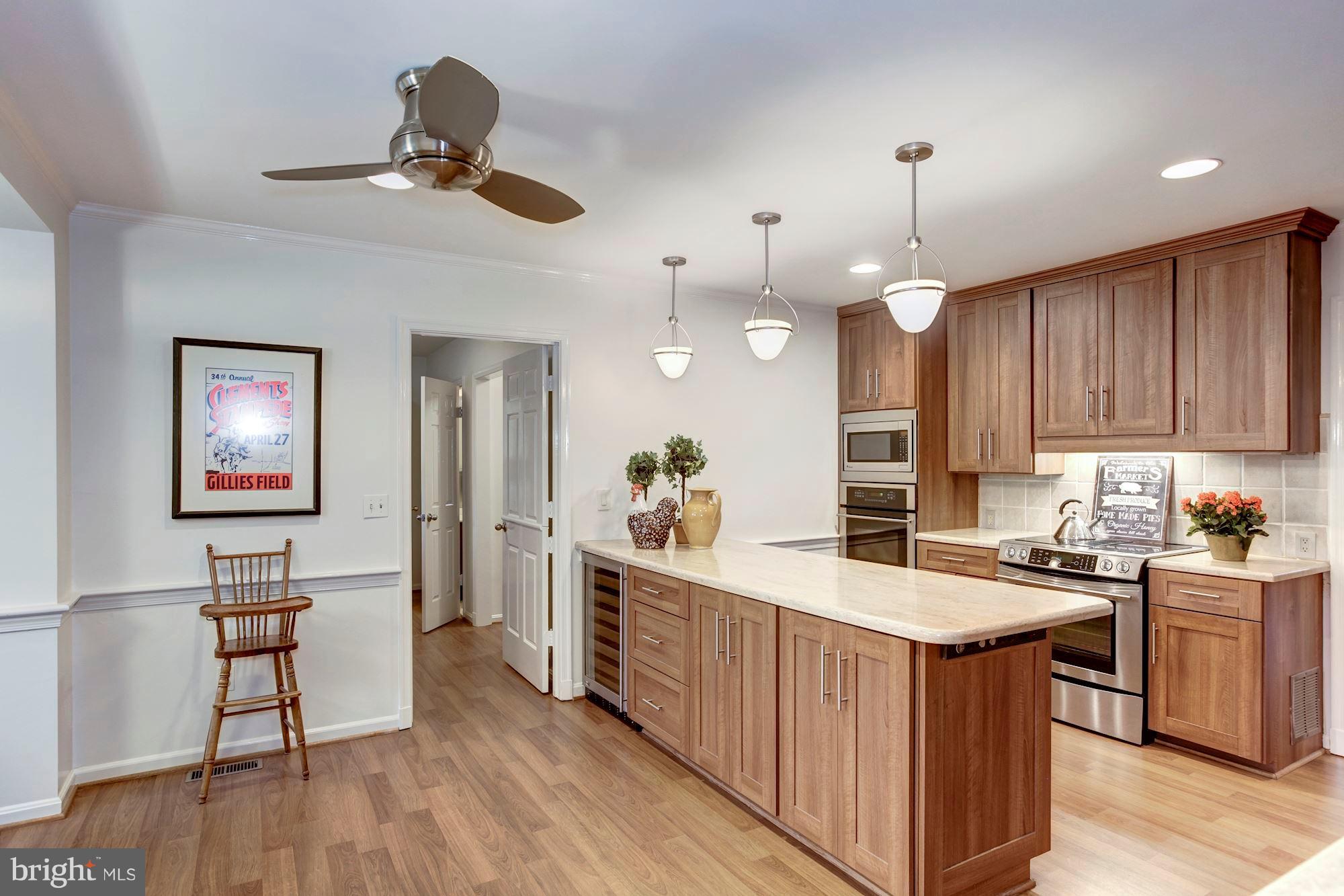 11000 Cripplegate Road Potomac, MD 20854 - Photo 10 of 44 a kitchen with a sink cabinets and wooden floor