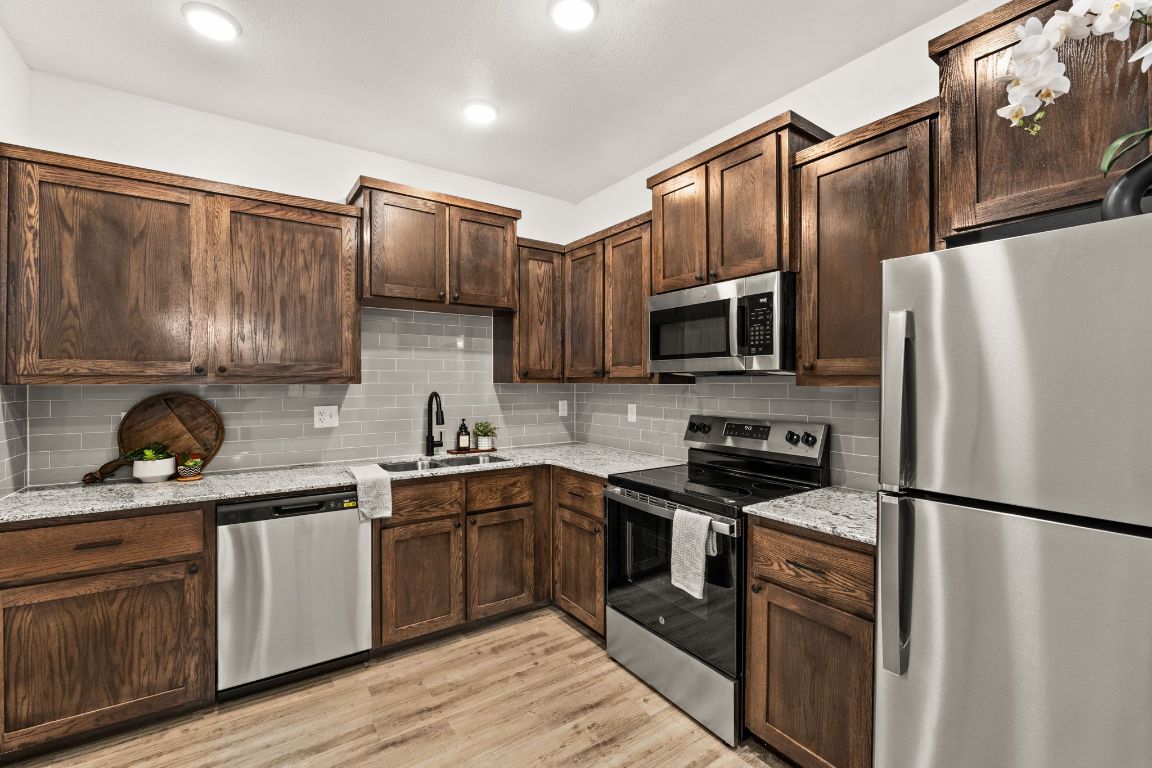 3602 Canvasback Road Killeen, TX 76542 - Photo 9 of 29 a kitchen with stainless steel appliances granite countertop a refrigerator stove microwave and sink