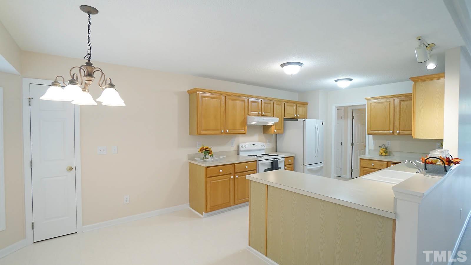 8316 Trumpetor Way Raleigh, NC 27613 - Photo 11 of 26 a kitchen that has a lot of cabinets and appliances