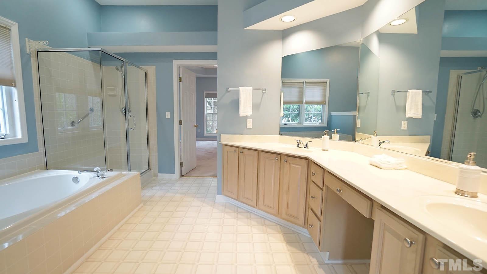 8316 Trumpetor Way Raleigh, NC 27613 - Photo 17 of 26 a spacious bathroom with a tub sink and mirror
