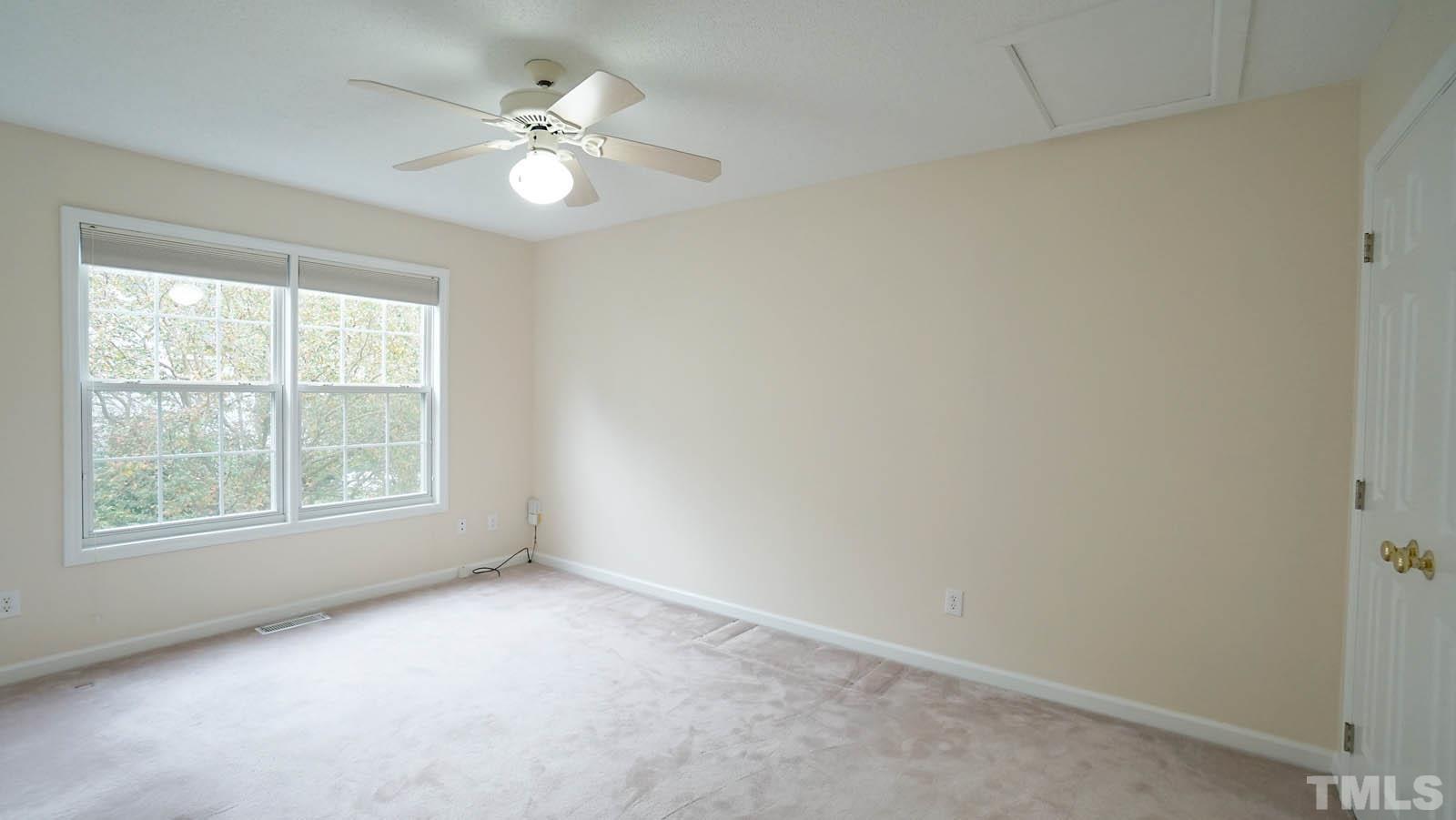 8316 Trumpetor Way Raleigh, NC 27613 - Photo 19 of 26 an empty room with windows and ceiling fan