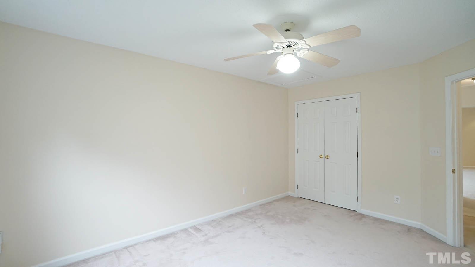 8316 Trumpetor Way Raleigh, NC 27613 - Photo 20 of 26 a view of an empty room with a chandelier fan