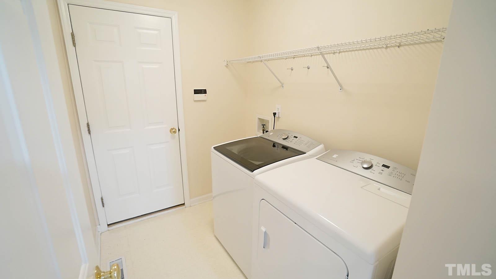 8316 Trumpetor Way Raleigh, NC 27613 - Photo 21 of 26 a utility room with dryer and washer