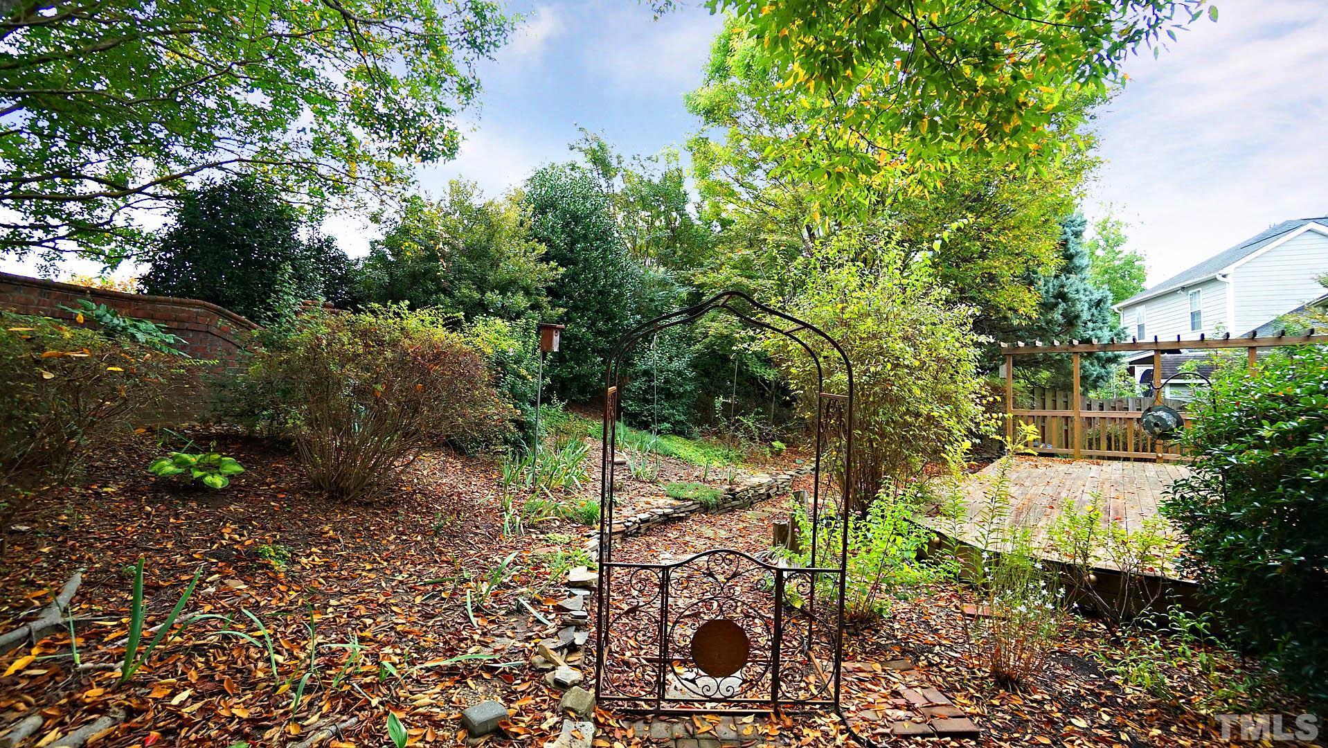8316 Trumpetor Way Raleigh, NC 27613 - Photo 26 of 26 a view of a yard with plants and large trees