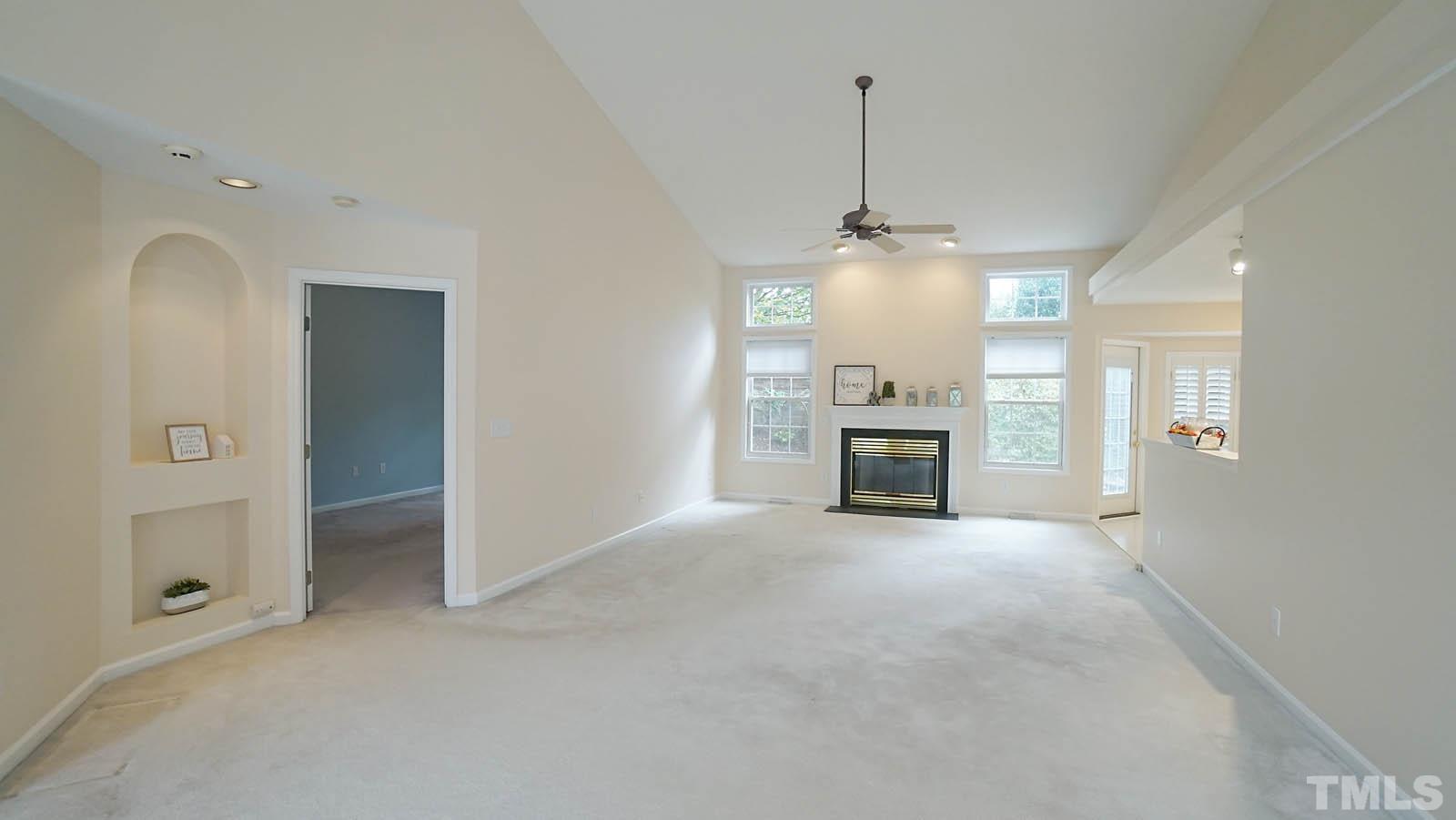 8316 Trumpetor Way Raleigh, NC 27613 - Photo 5 of 26 a view of a livingroom with a chandelier and fireplace