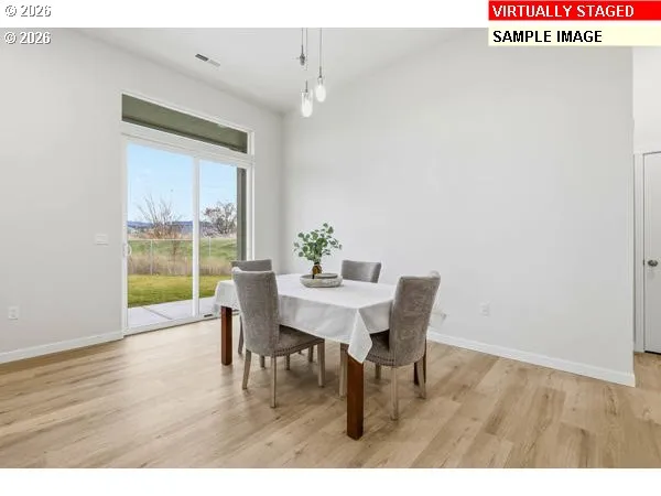 a dining room with furniture and wooden floor