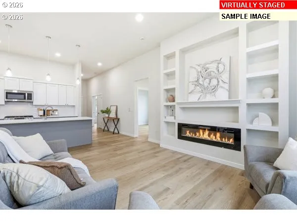 a living room with furniture and kitchen view