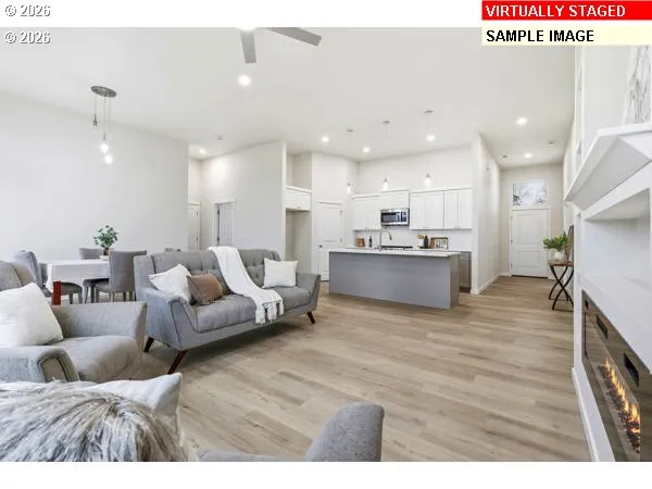 a living room with furniture and a wooden floor