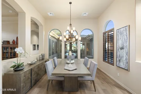 a kitchen with granite countertop kitchen island stainless steel appliances a sink and a refrigerator