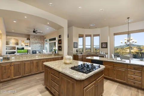 a kitchen with stainless steel appliances granite countertop a stove a sink and a granite counter tops