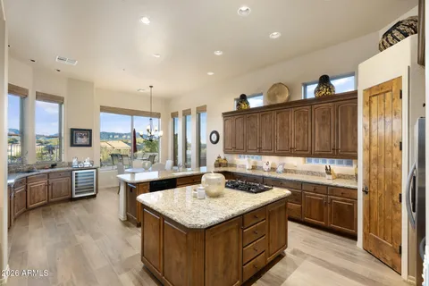 a view of a kitchen with granite countertop a sink and a window