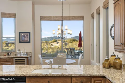 a view of a dining room with furniture a chandelier and wooden floor